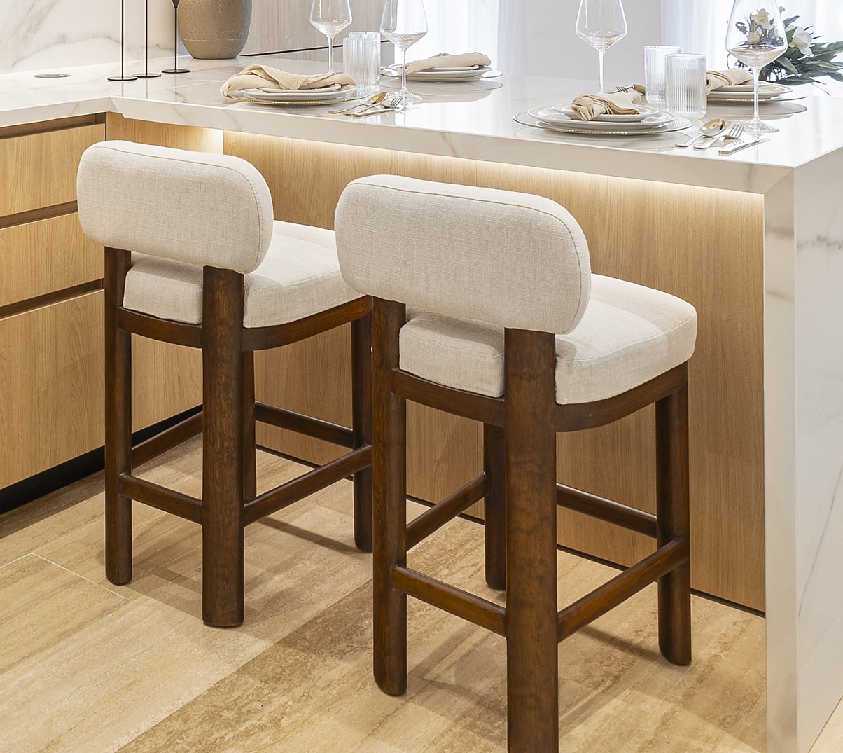 Cream upholstered bar stools with chunky dark wood legs
