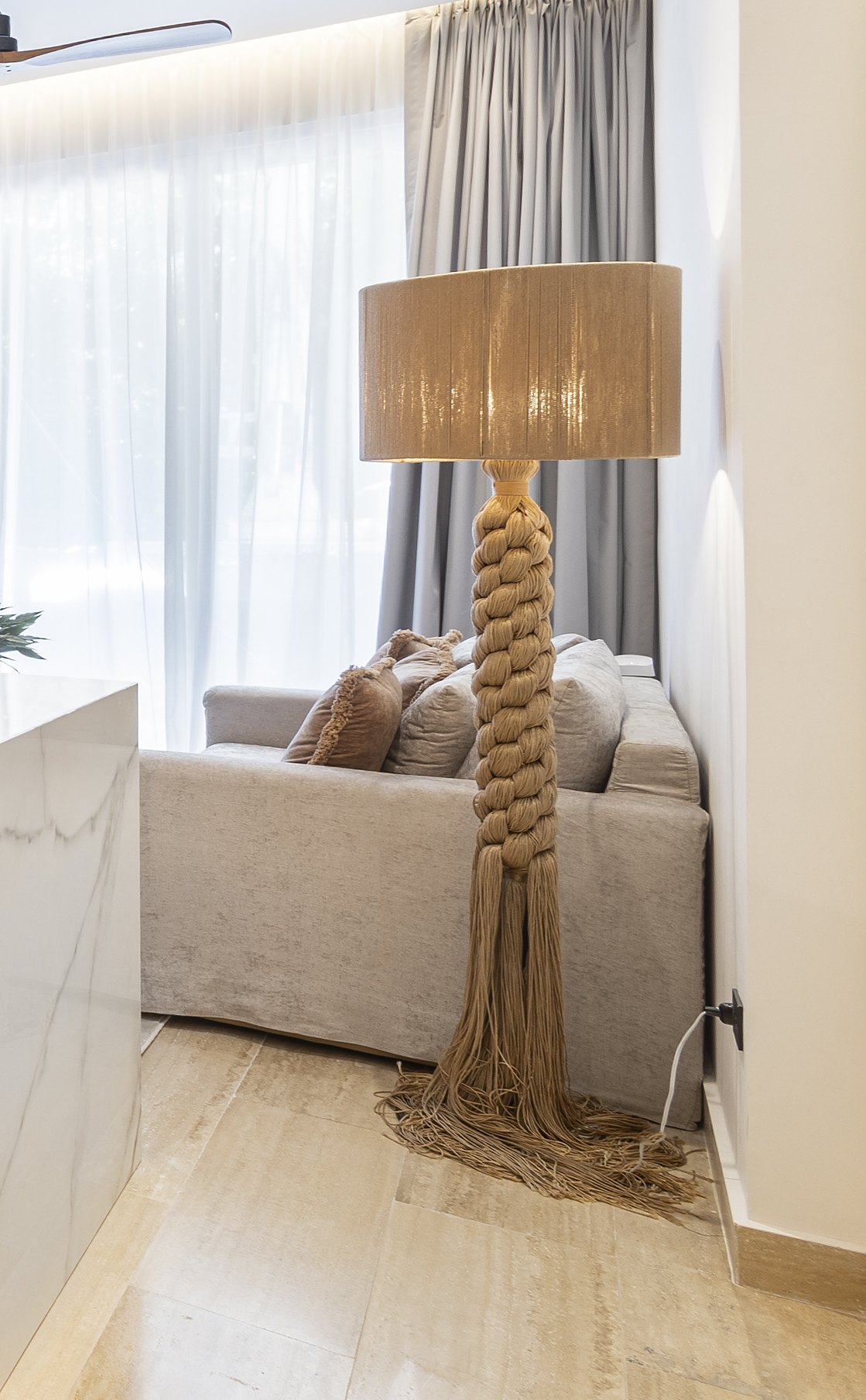 Braided rope floor lamp with a long tassel and a woven drum shade