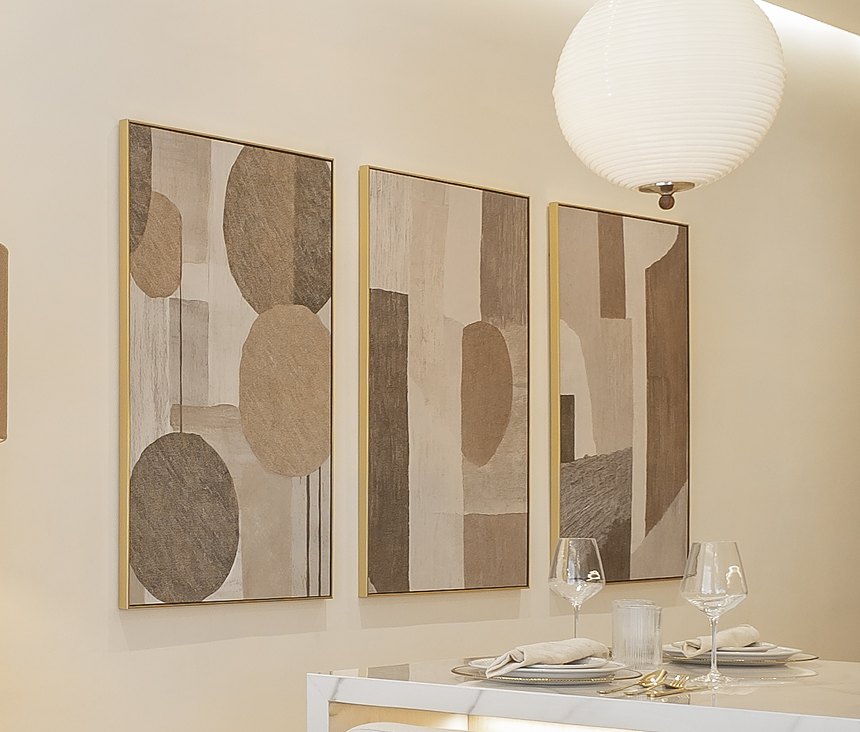 Three framed abstract prints in sand and taupe tones